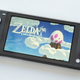 The Nintendo Switch Lite in gray, with The Legend of Zelda Link's Awakening on screen, photographed against a white background.